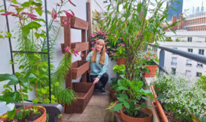 How can adding one comfortable outdoor chair encourage you to enjoy your balcony garden more often