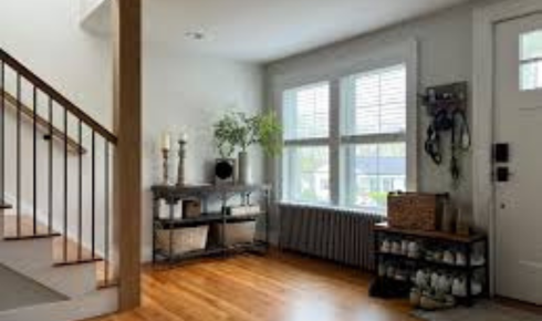 How can placing a small side table between two chairs create a more usable conversation corner