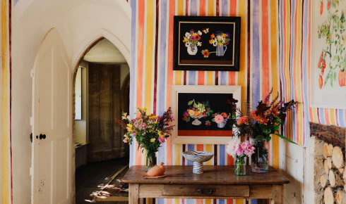 How can placing a tray with a candle, book and small decor piece on the coffee table make it look styled, not cluttered
