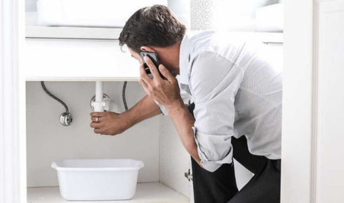 How can using a drain cover in the shower stop hair from clogging pipes