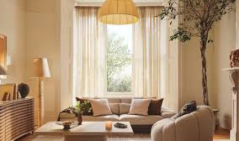 What difference does using see-through shelves or glass units make in keeping a room from feeling heavy